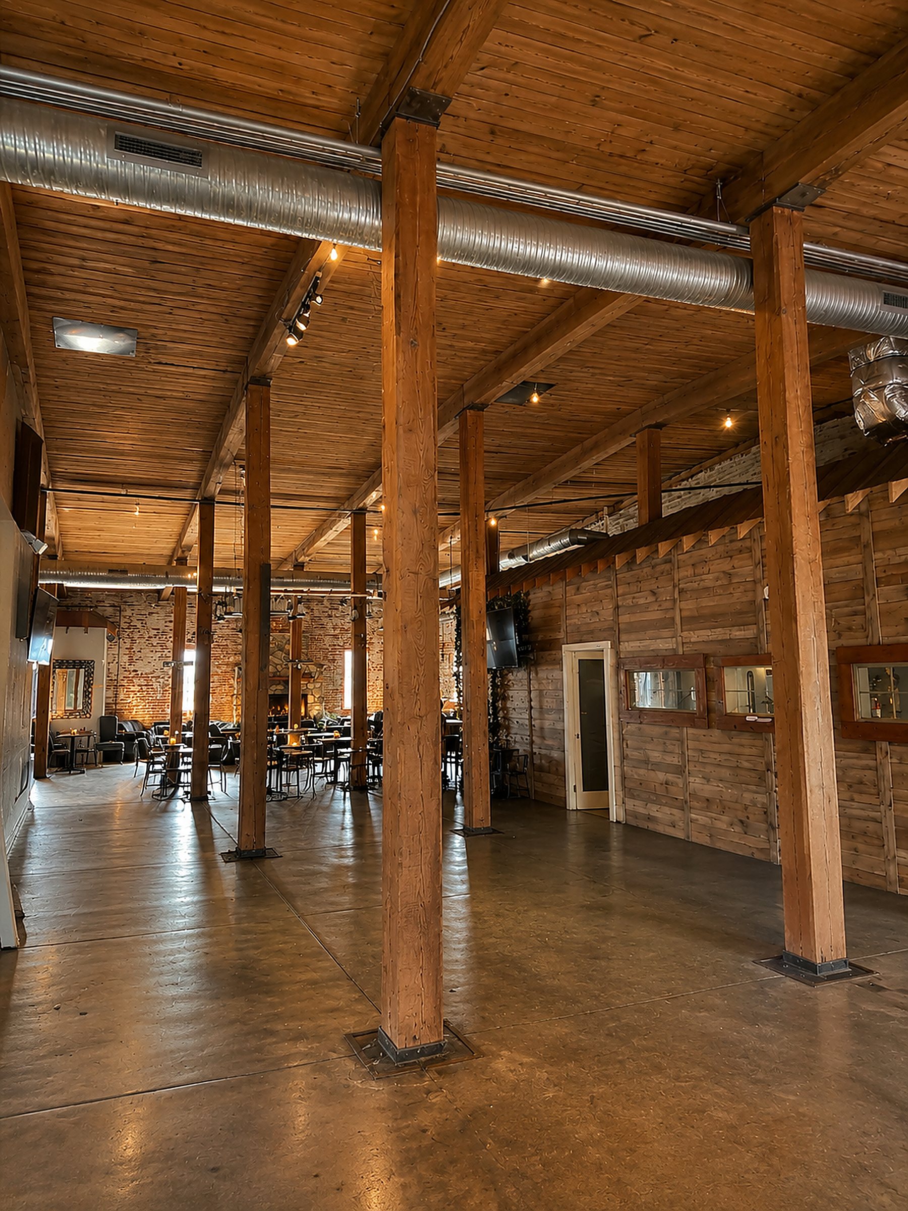 Suite G open industrial hall in daylight with timber columns and ductwork